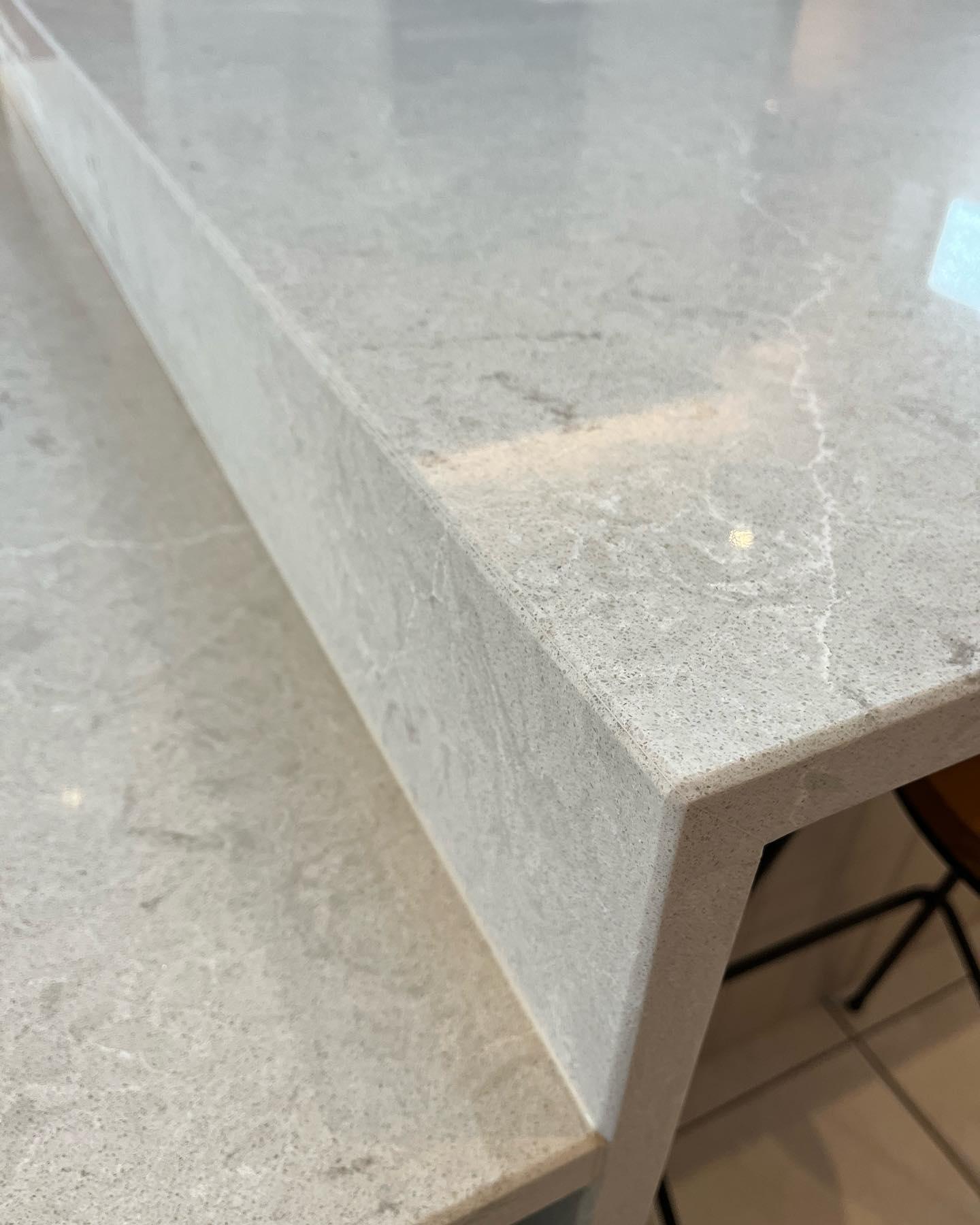 Waterfall edge detail on a stone island, NC Worksurfaces craftsmanship